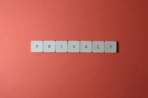 Close-up of letter tiles spelling PRIVACY on a red background, symbolizing data protection.